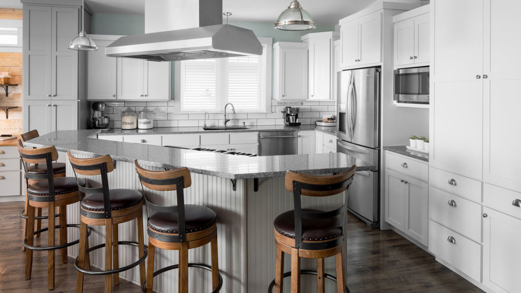 Gray and white shaker kitchen cabinets, custom island, quartz countertops, and stainless appliances.