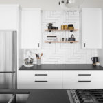 White Euro cabinets in modern kitchen with black granite countertops and stainless steel appliances.